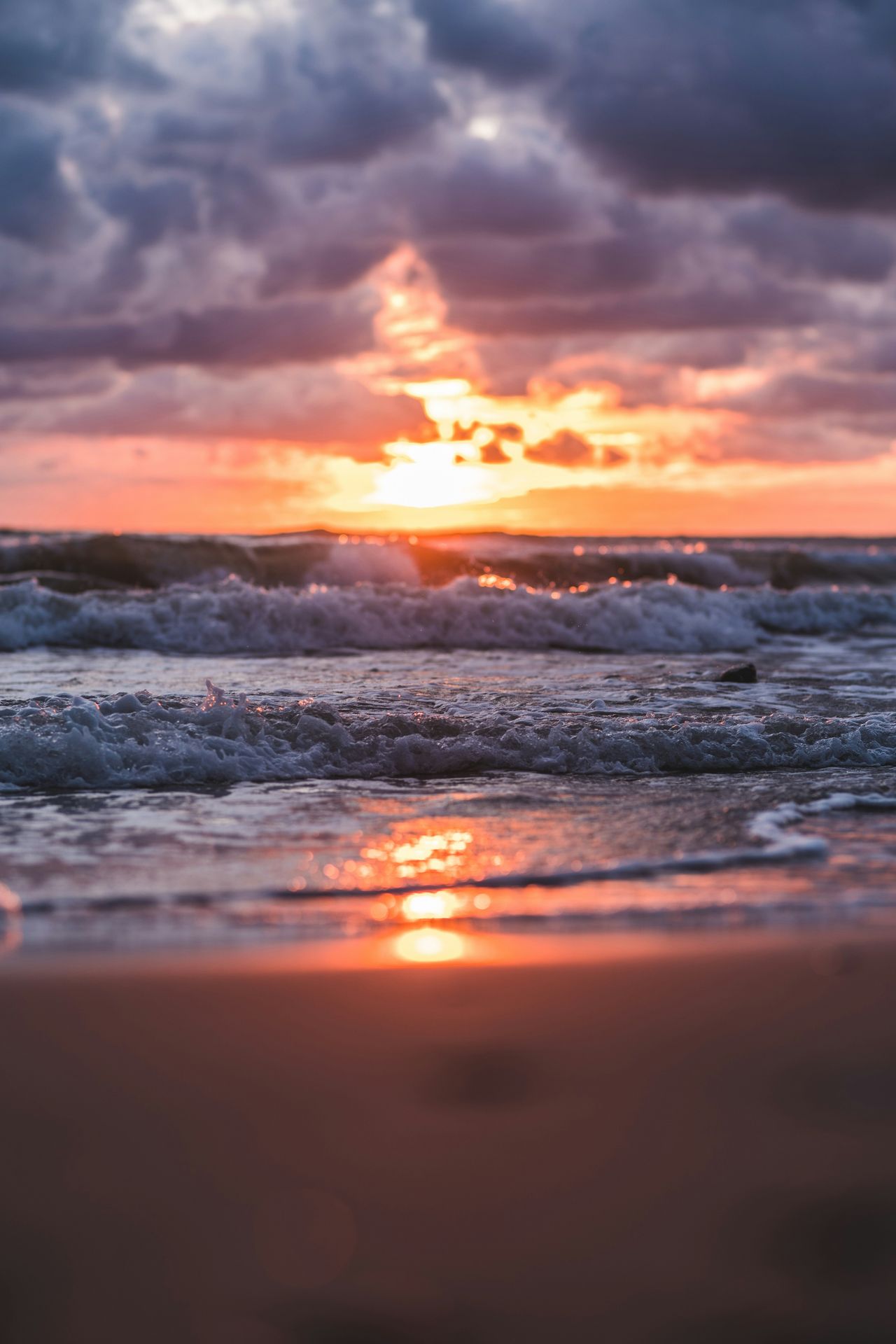 Photo of a sun breaking through dark clouds over the ocean, demonstrating how change may be inevitable, and can be difficult, but counseling can help guide you through the transition.
