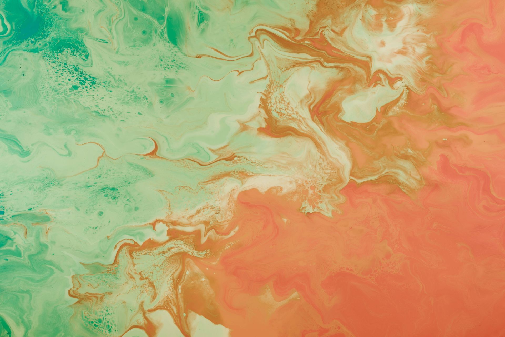 Photo of water breaking onto sand, colord aqua and orange, demonstrating how change can blur the lines in life and create different transitions.