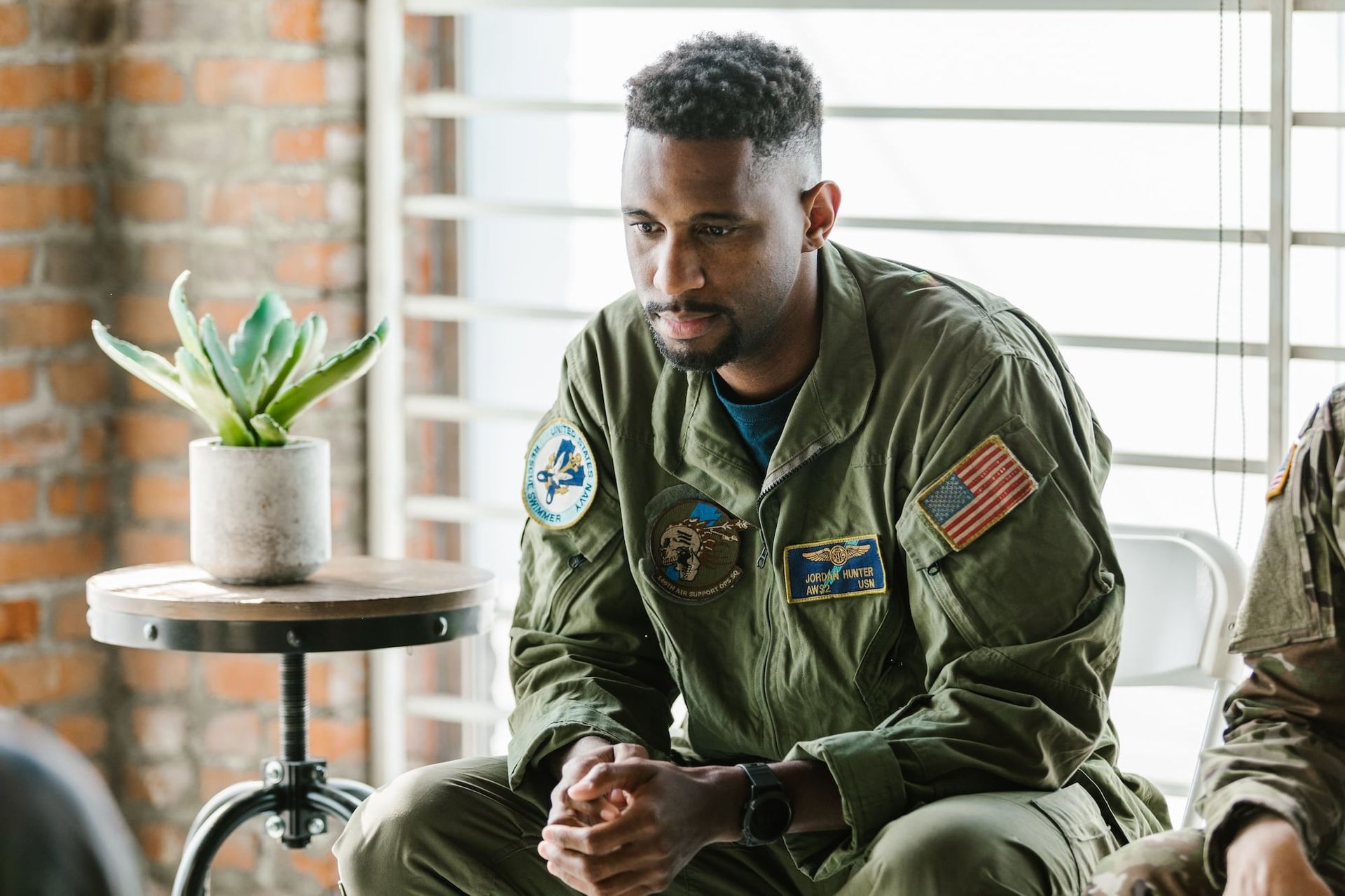 Navy veteran sitting deep in thought.