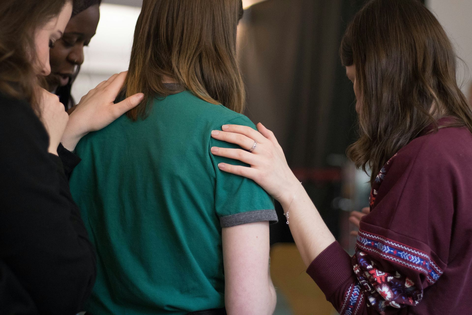 teen girls praying together