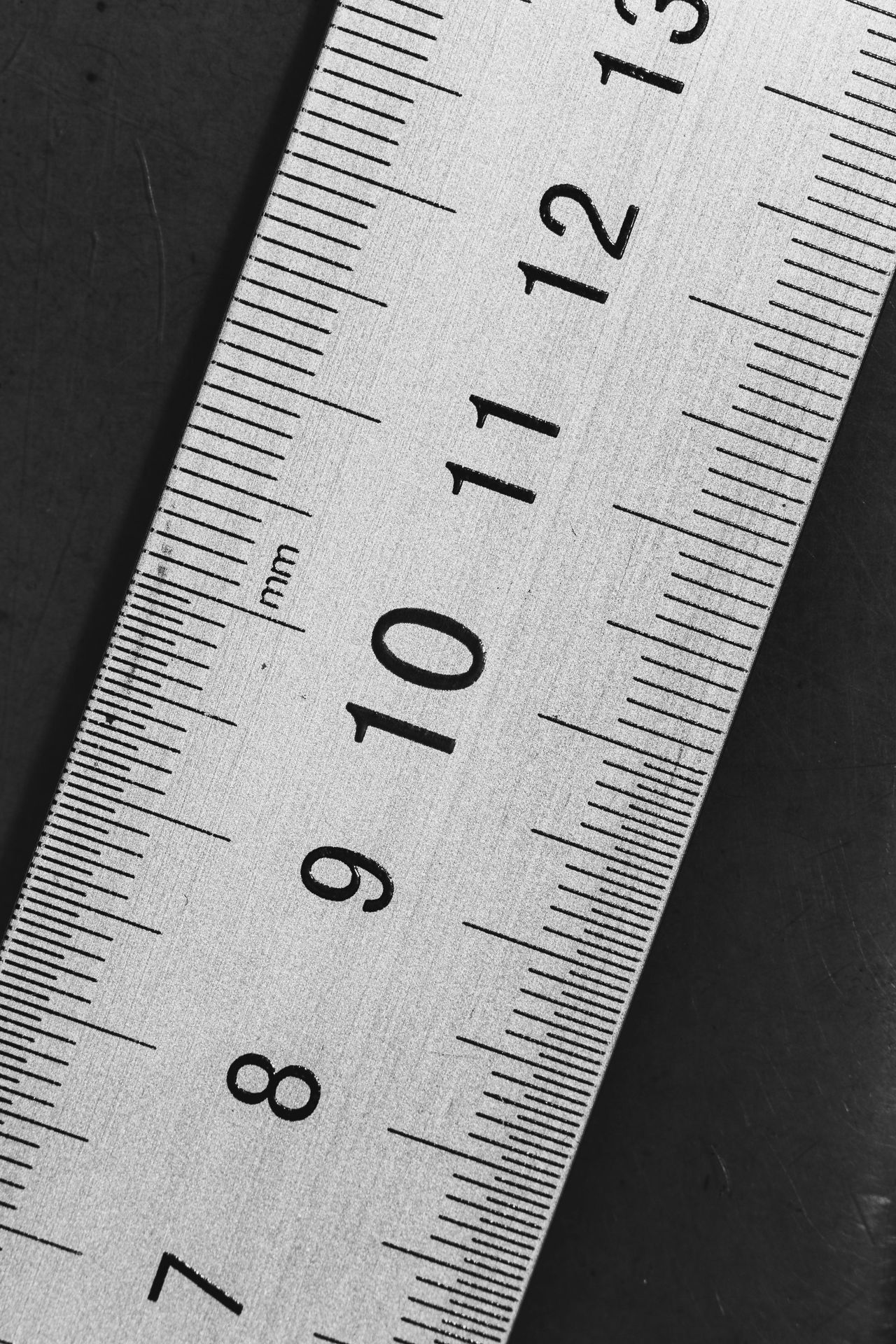 A black and white picture of a ruler with the numbers 7 through 11 visible.