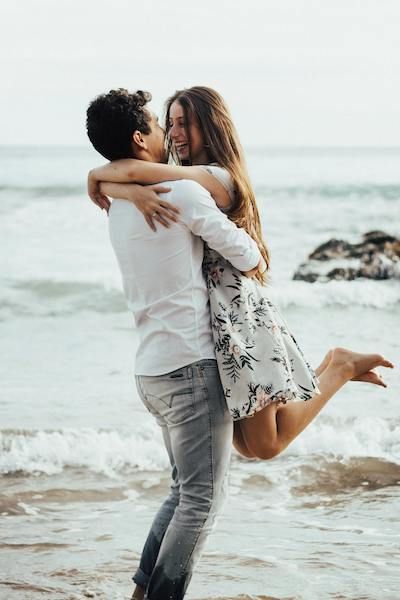 couple embracing by ocean