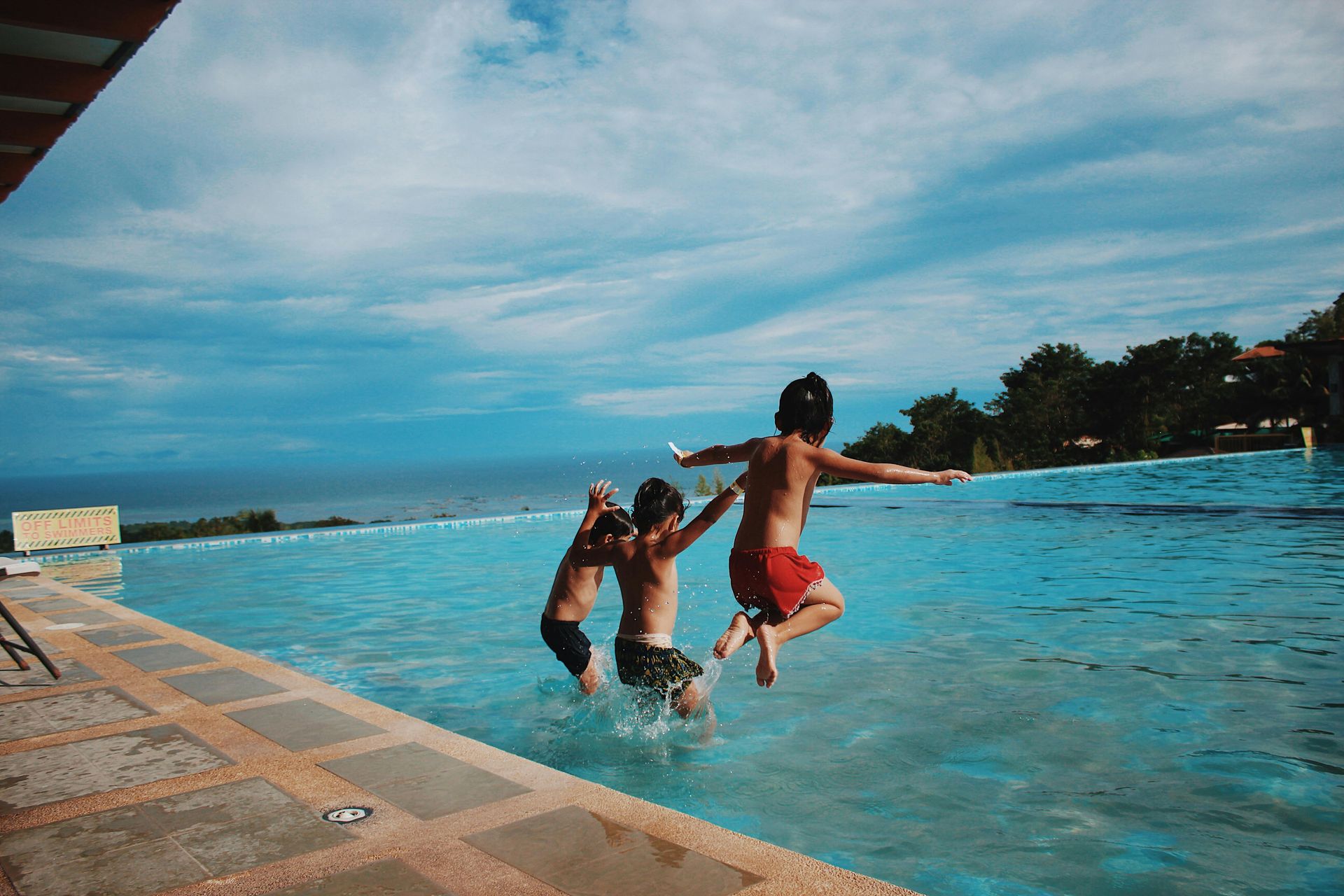 three kids jumping into a pool. 45 regulation activities to boost well-being