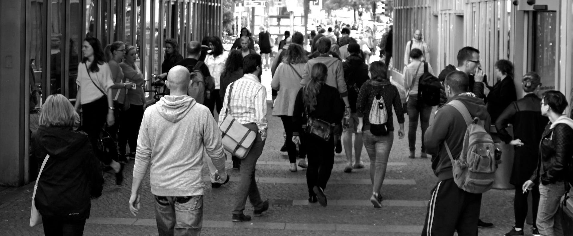 group of people walking outside on a sidewalk in black and white; 1 in 5 people in the U.S. experience anxiety