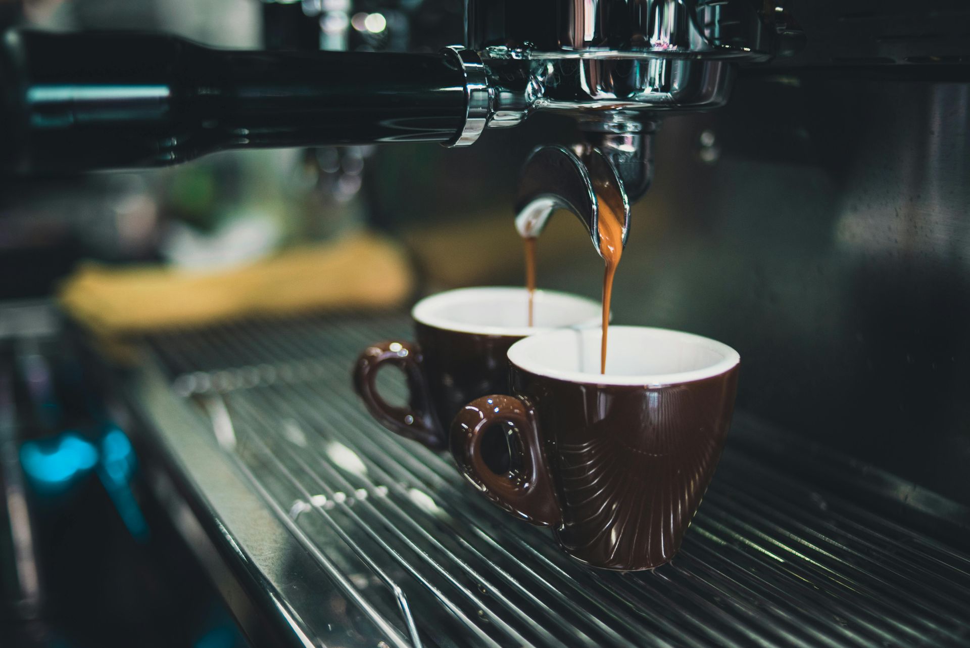 two espresso cups being filled by espresso machine. Coffee and caffeine can negatively impair sleep quality