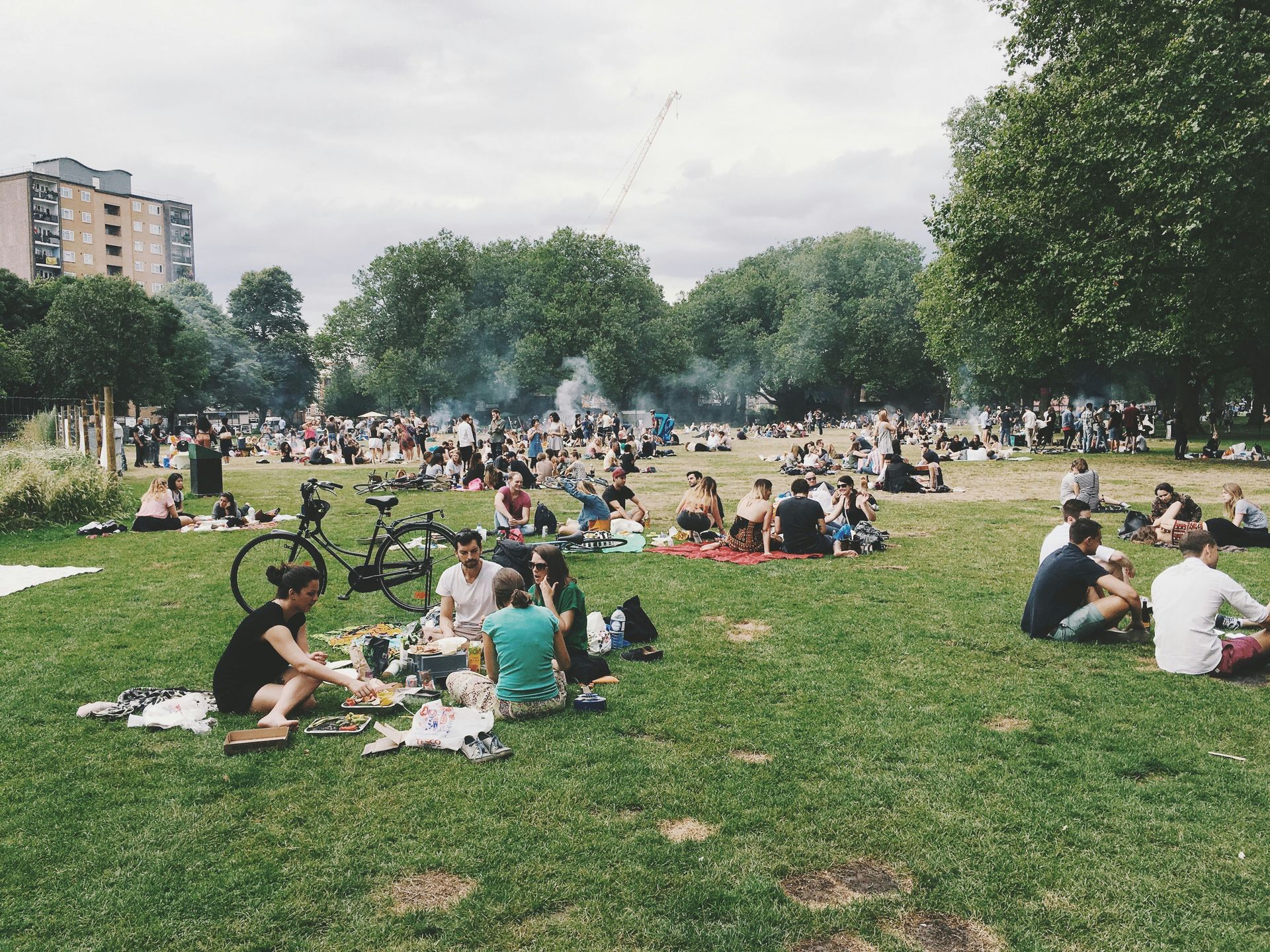 groups of people sitting at a public park. Habits that improve mental health
