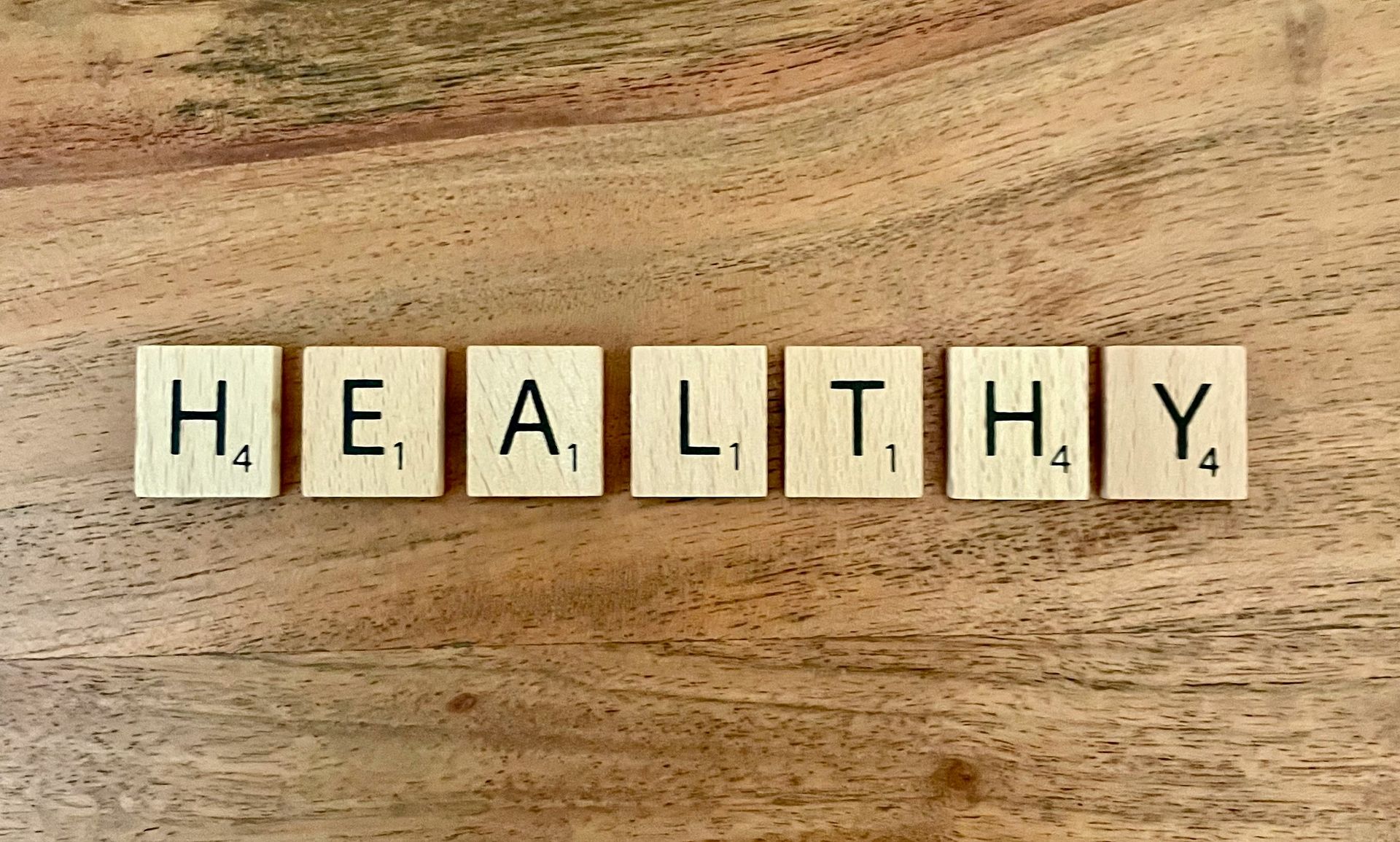 scrabble tiles on a wood table spelling: "Healthy". Connection between sleep and mental health depression and anxiety