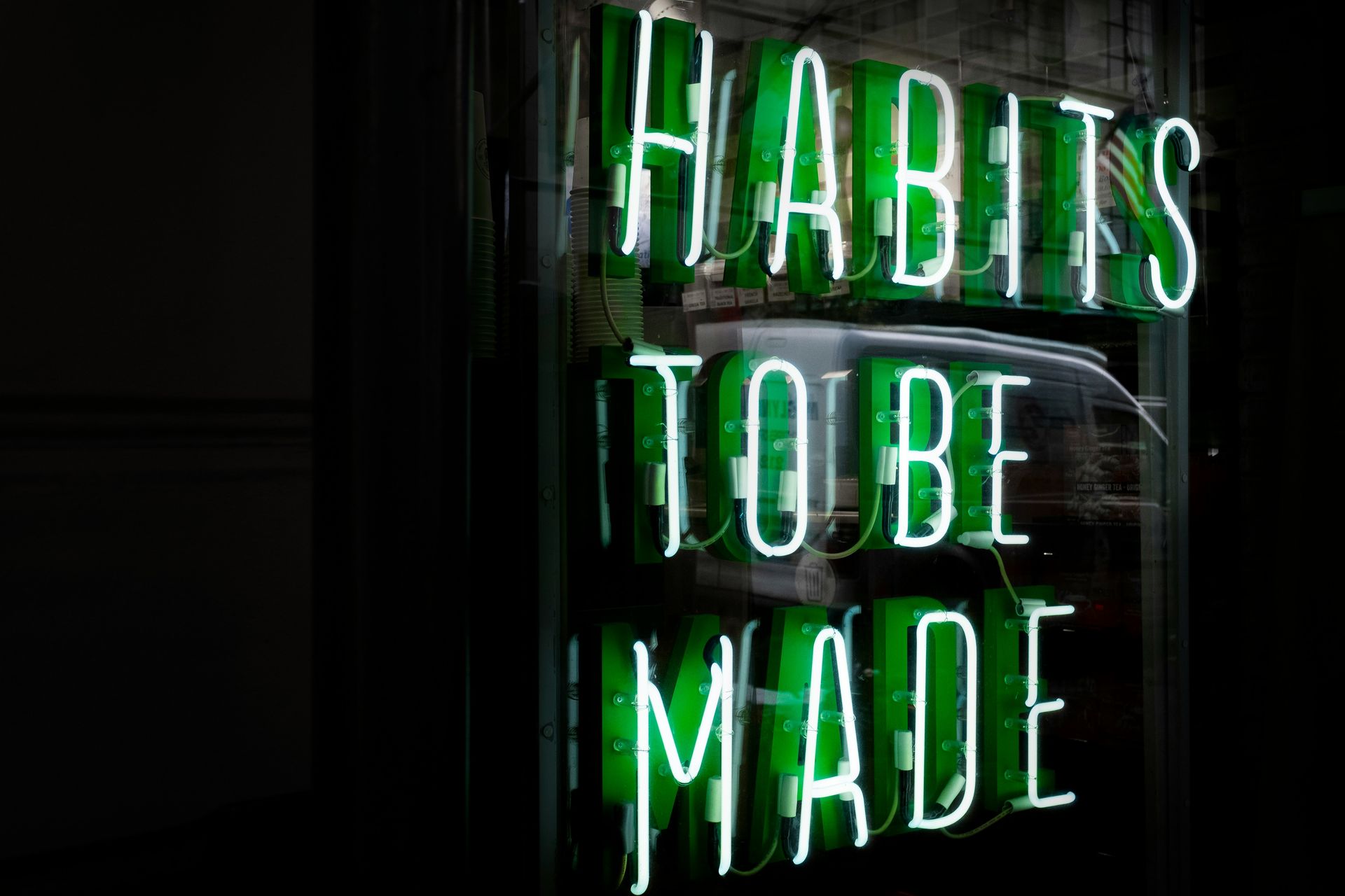green neon lights spelling out: "Habits to Be Made" Habits thatt improve mental health (at any age)