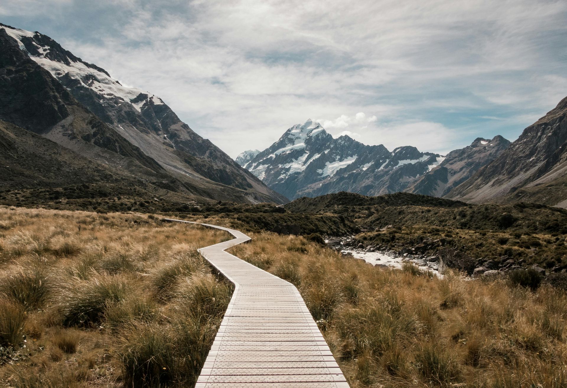boardwalk path through wilderness and views of snow capped mountains
