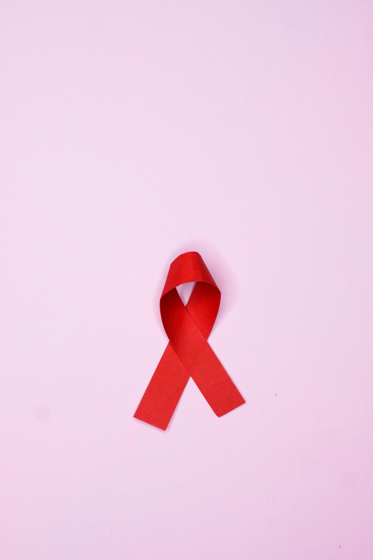 AIDS red ribbon and pink background