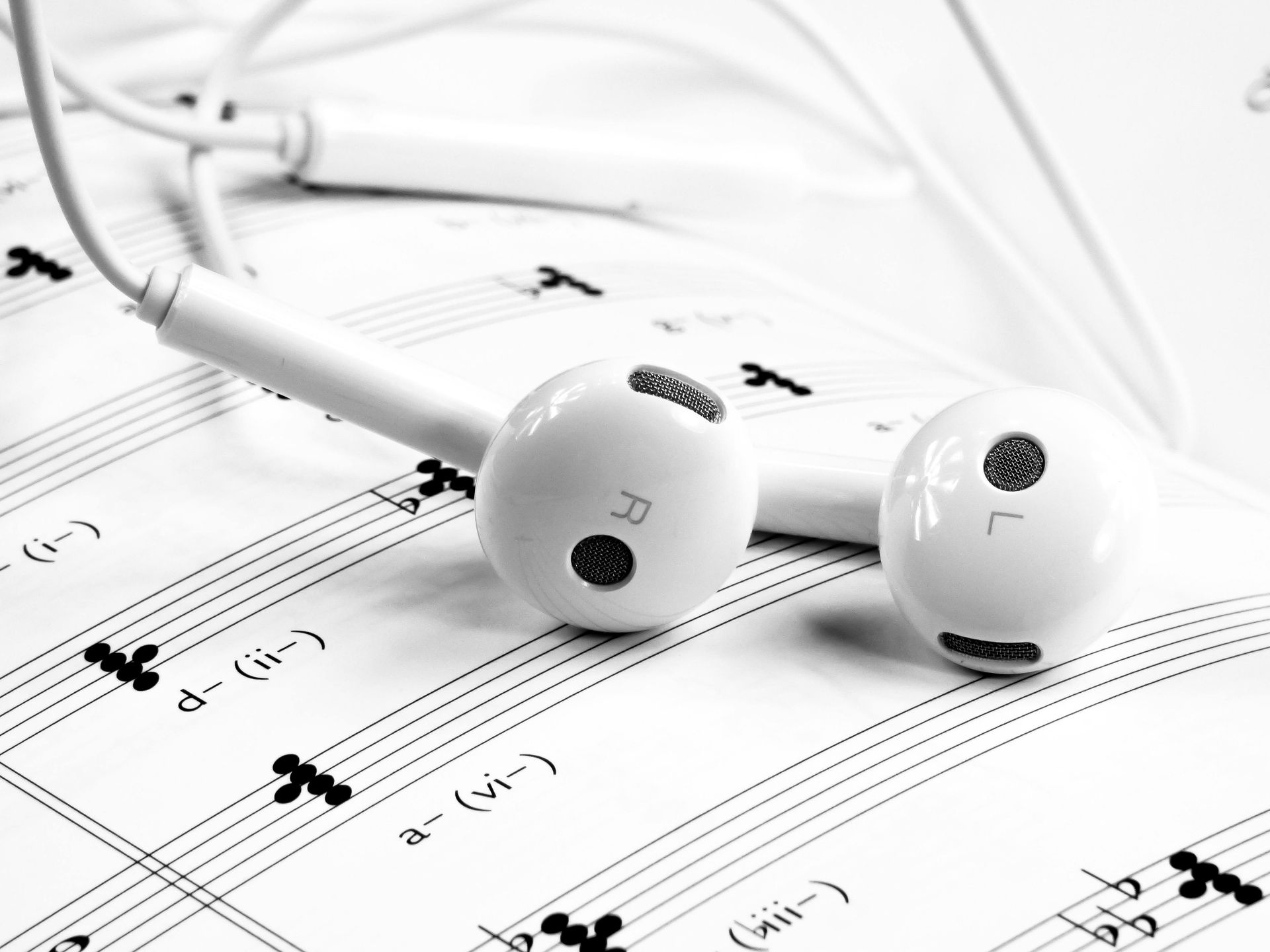 white head phones on sheet music. music for anxiety. anxiety coping skills