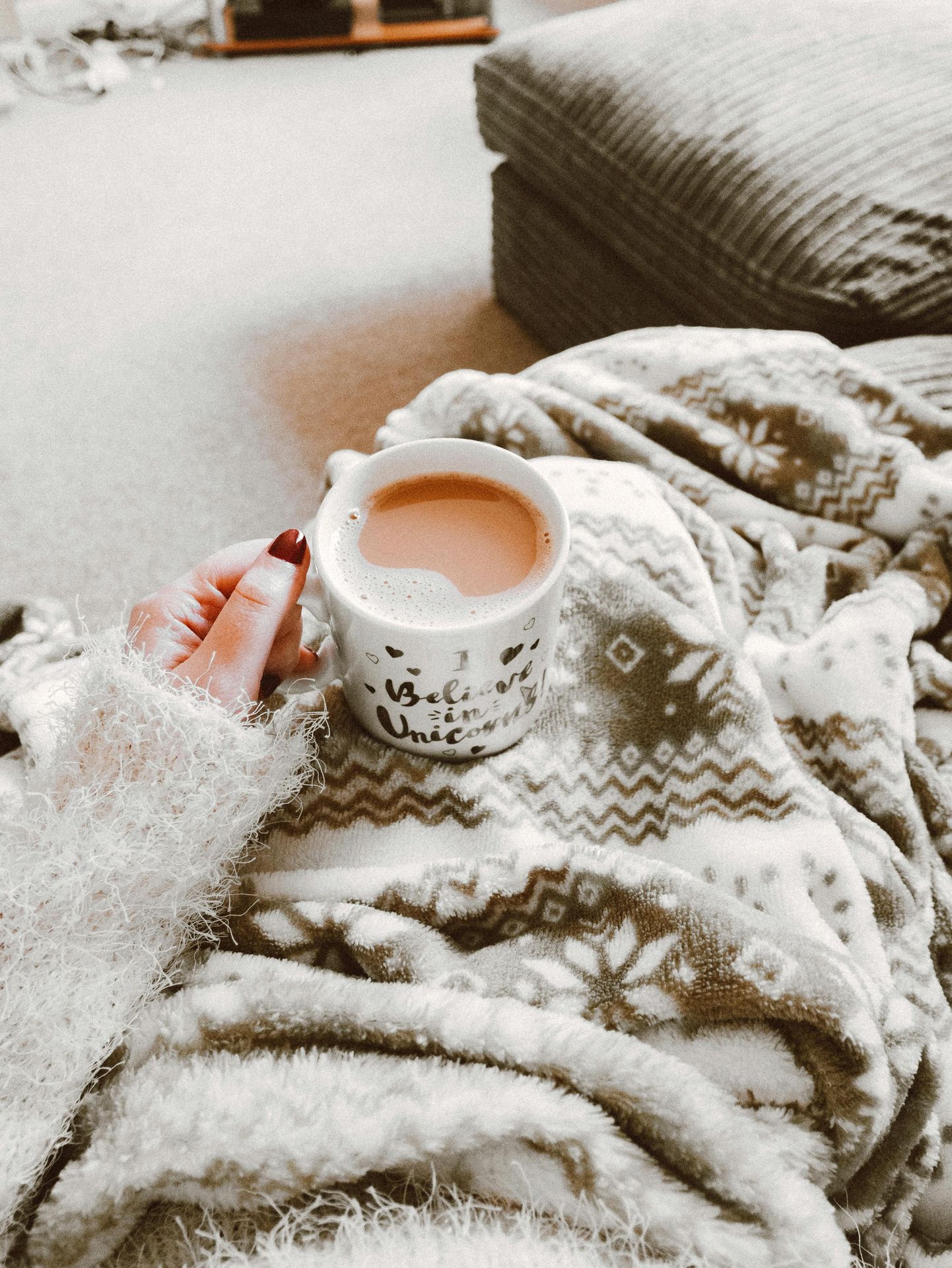 soft blanket on the lap of a person holding a mug with tea. 45 regulation activities to boost well-being