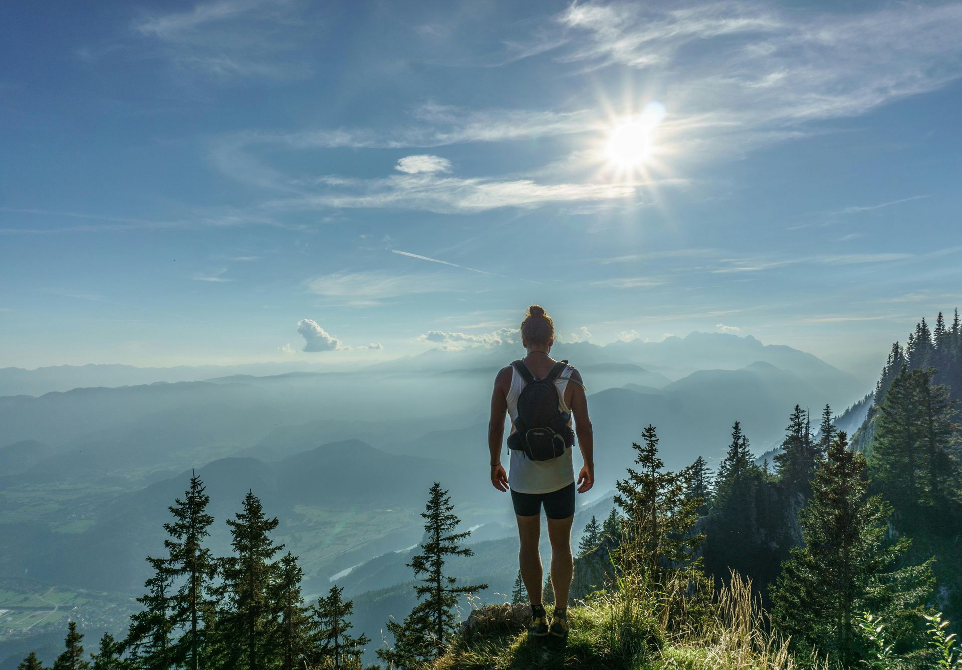 woman overlooking the view from the side of a mountain. Hike or walk for anxiety. Anxiety coping skills. Outdoor therapy for anxiety