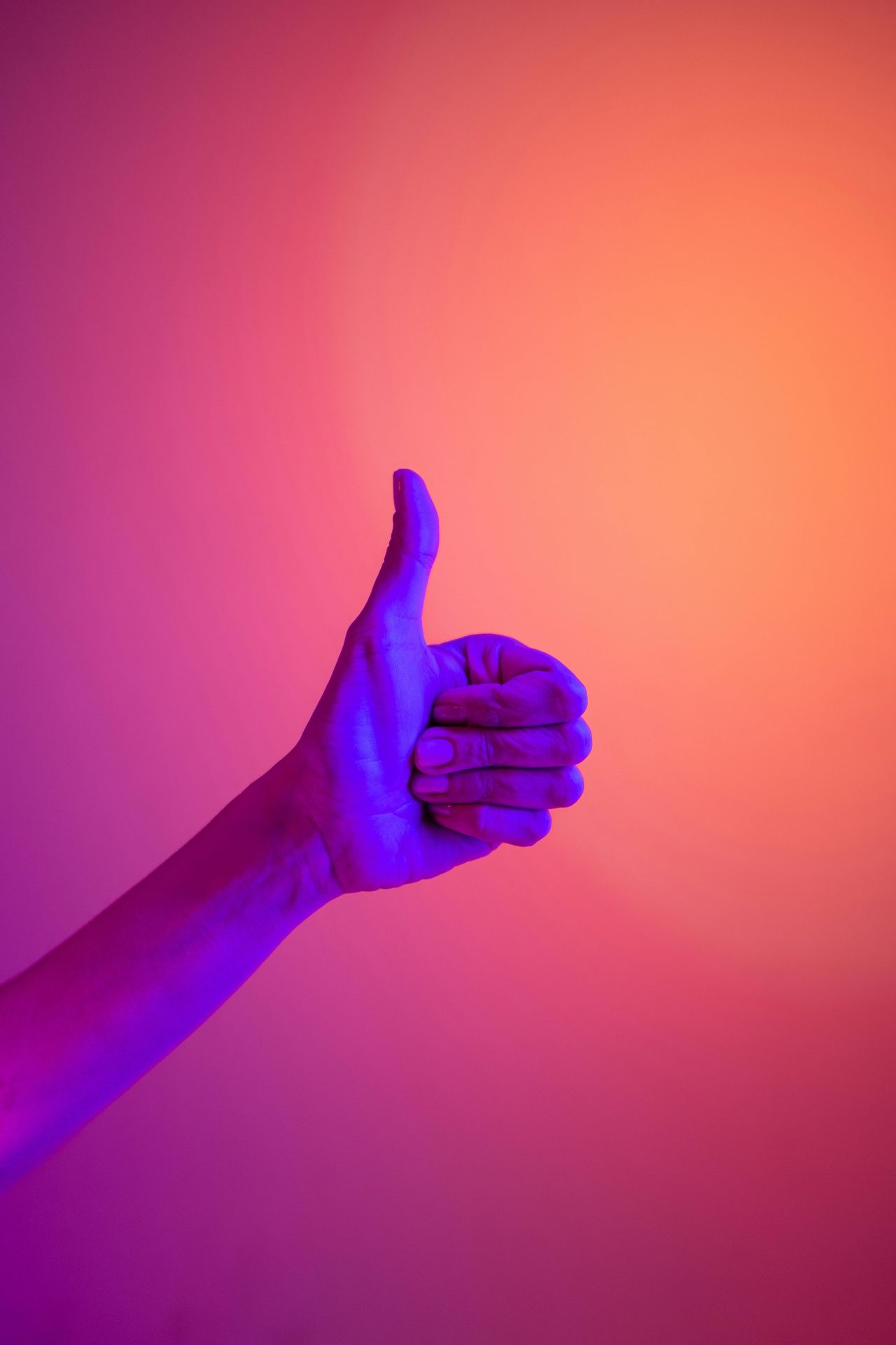 hand gesturing "thumbs up" and projected in purple light against a purple and orange background. Stellar insight Counseling Group Therapy Services Alaska