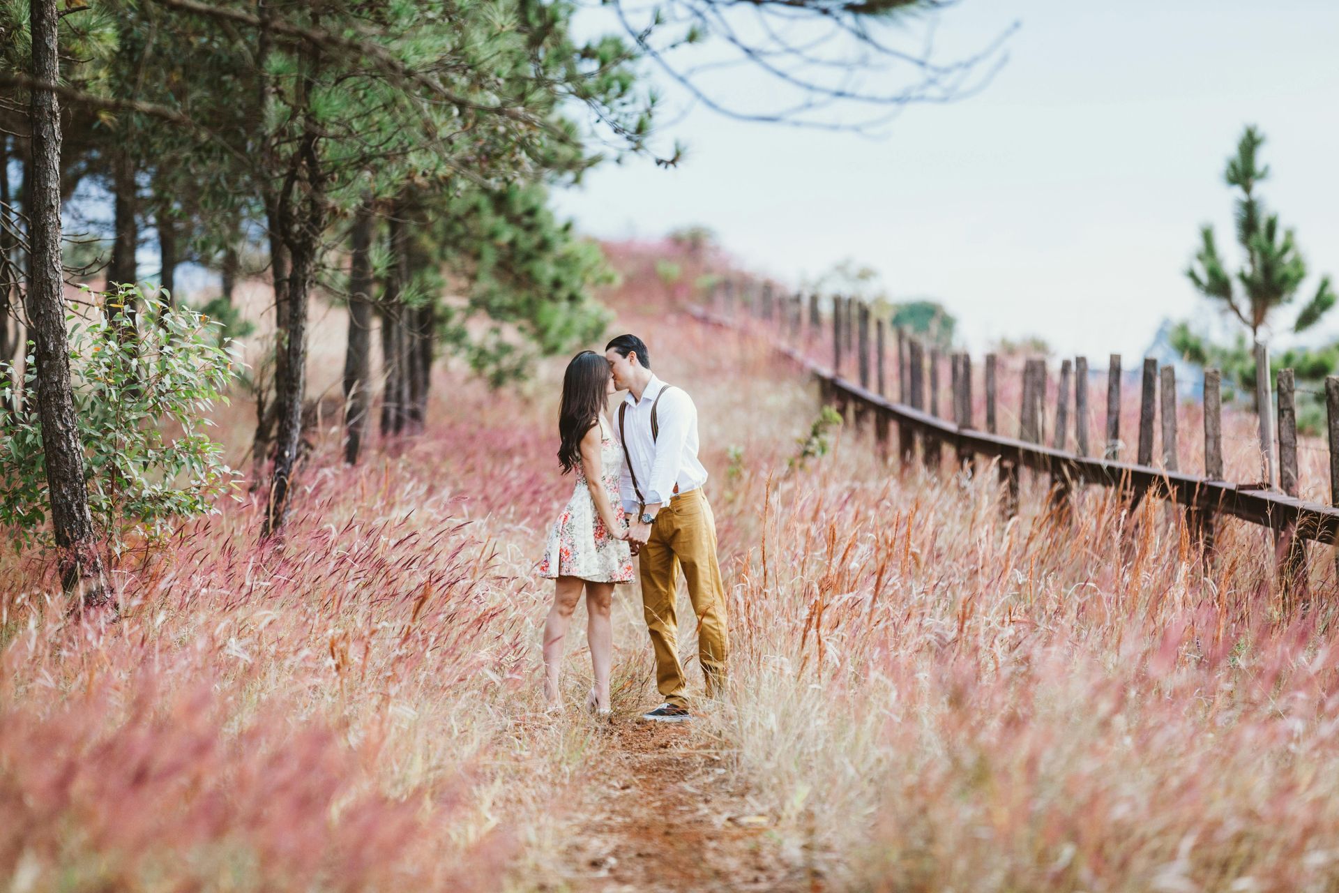 couple standing in field for engagement photo
