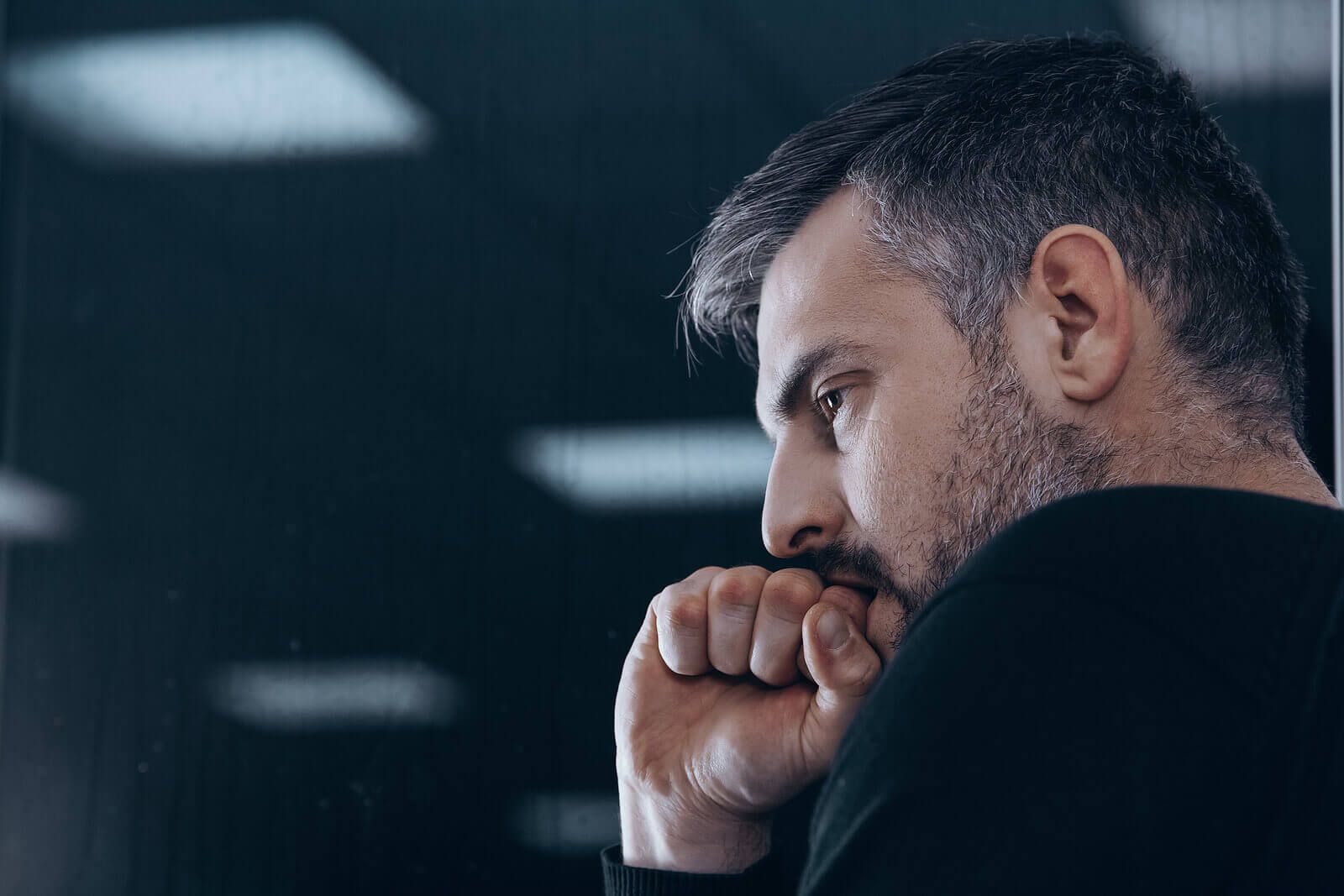 A man biting his fist representing anger | grief counseling san francisco, ca | grief therapist in san francisco, ca | grief therapy in san francisco, ca | 94609 | 94061 | 94941
