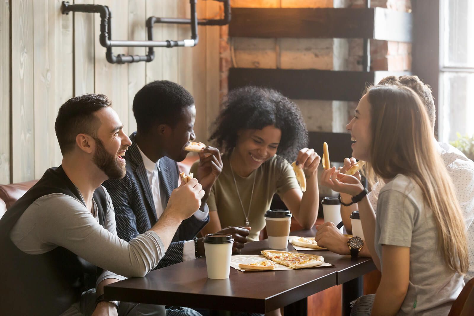 A group of diverse friends sharing pizza | men's therapy san francisco, ca | men's counseling san francisco, ca | online men's issues counseling california | 94110 | 94112 | 94116