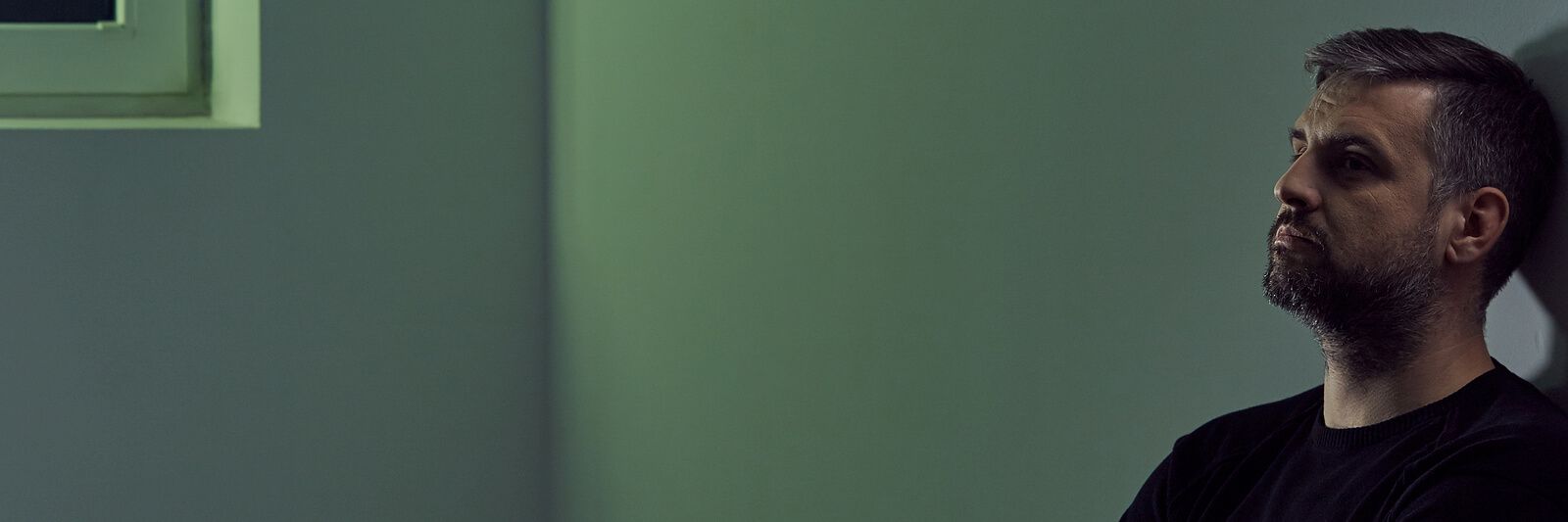 A man sitting alone against a wall | men’s issues in san francisco, ca | counseling for men san Francisco | men's therapy san francisco, ca | 94607 | 94608 | 94609