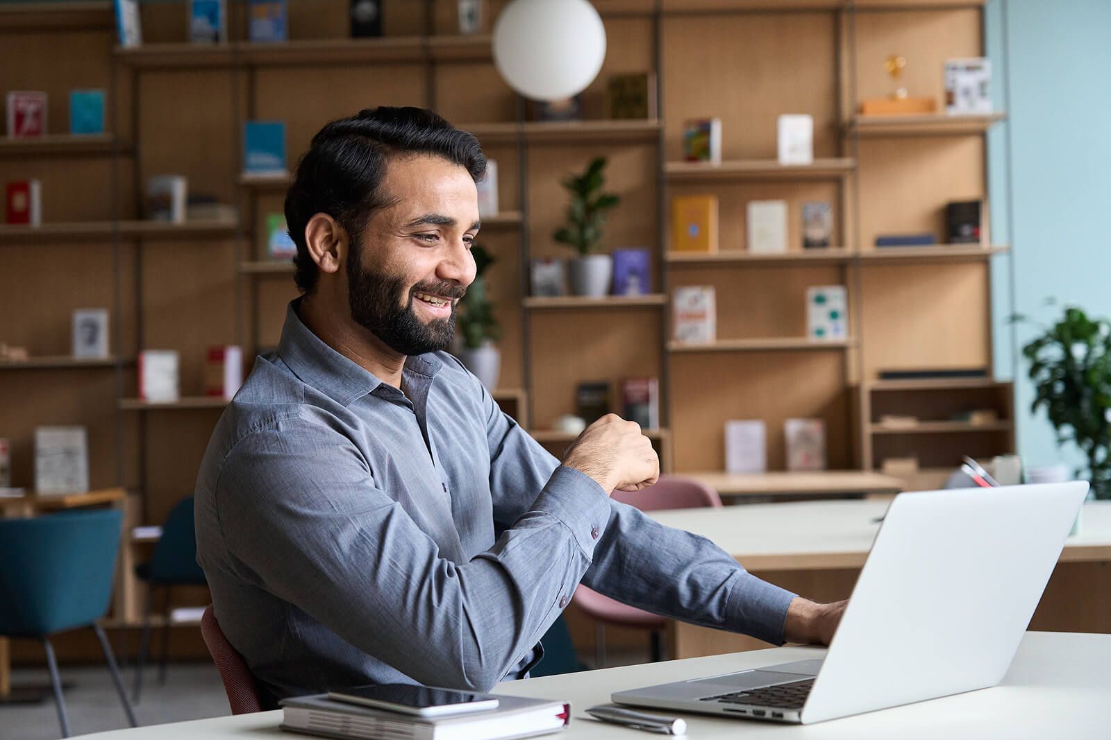 A man smiling at his computer while working | men's therapy san francisco, ca | counseling for men san Francisco | men's therapist san francisco, ca | 94112 | 94116 | 94117