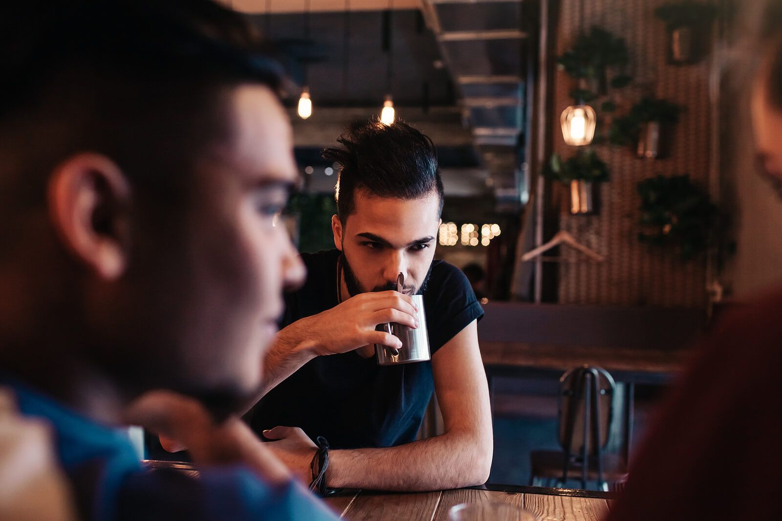 A man sitting drinking coffee with a friend | men’s issues in san francisco, ca | men's therapy san francisco, ca | counseling for men san francisco | 94608 | 94609 | 94061