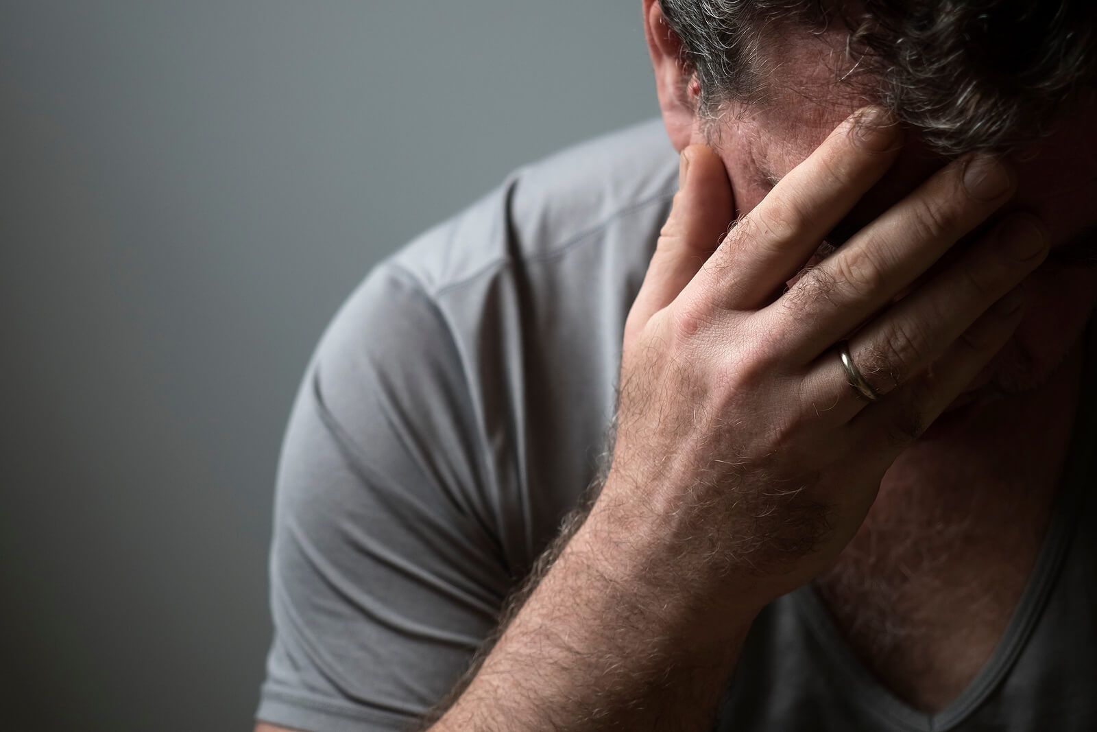 A man covering his face with his hands | men's therapy san francisco, ca | men's counseling san francisco, ca | online men's issues counseling california | 94110 | 94112 | 94116