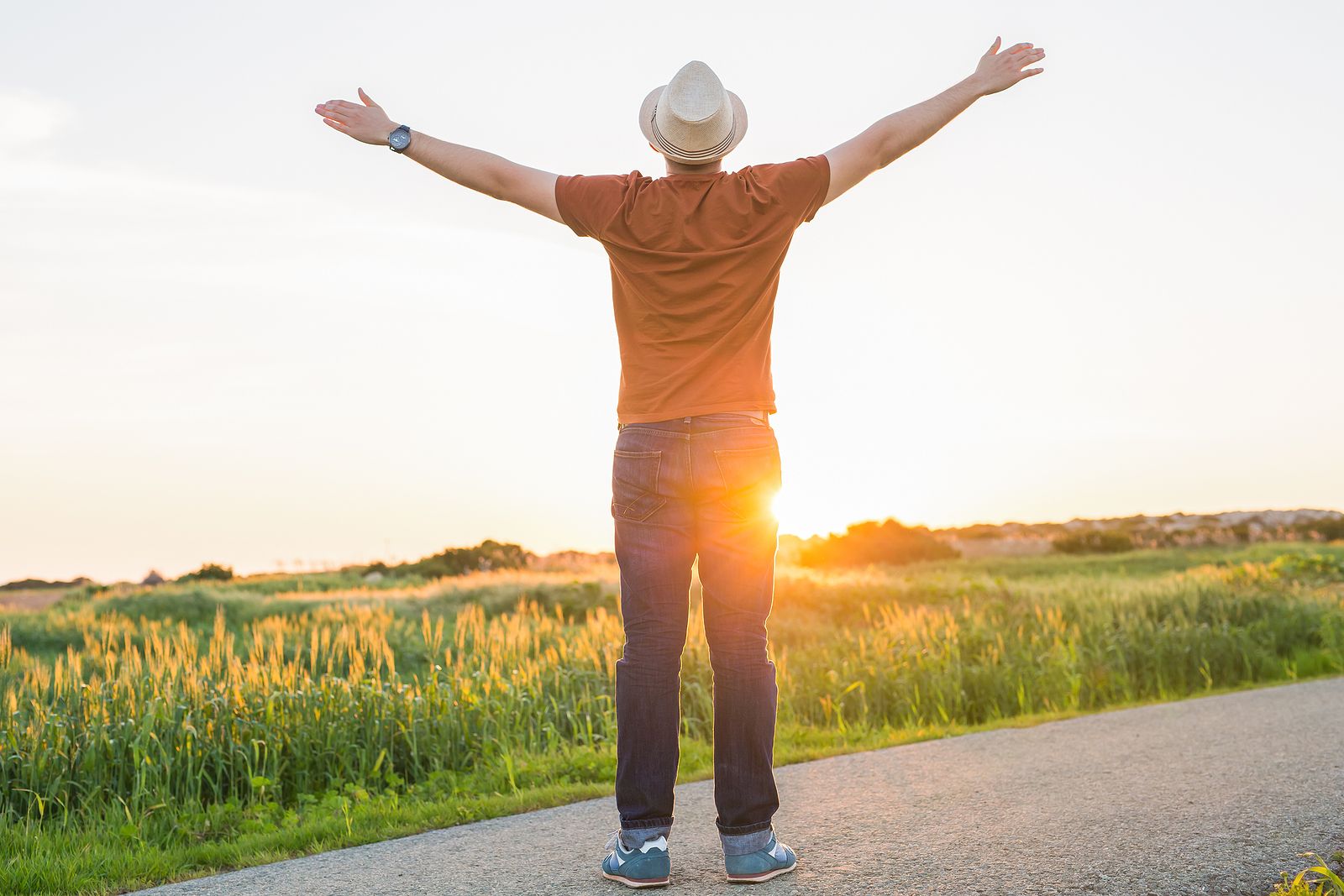 A man standing near a field with his arms spread open | grief therapist in san francisco, ca | grief therapy in san francisco, ca | grief counseling san francisco, ca | 94110 | 94112 | 94116