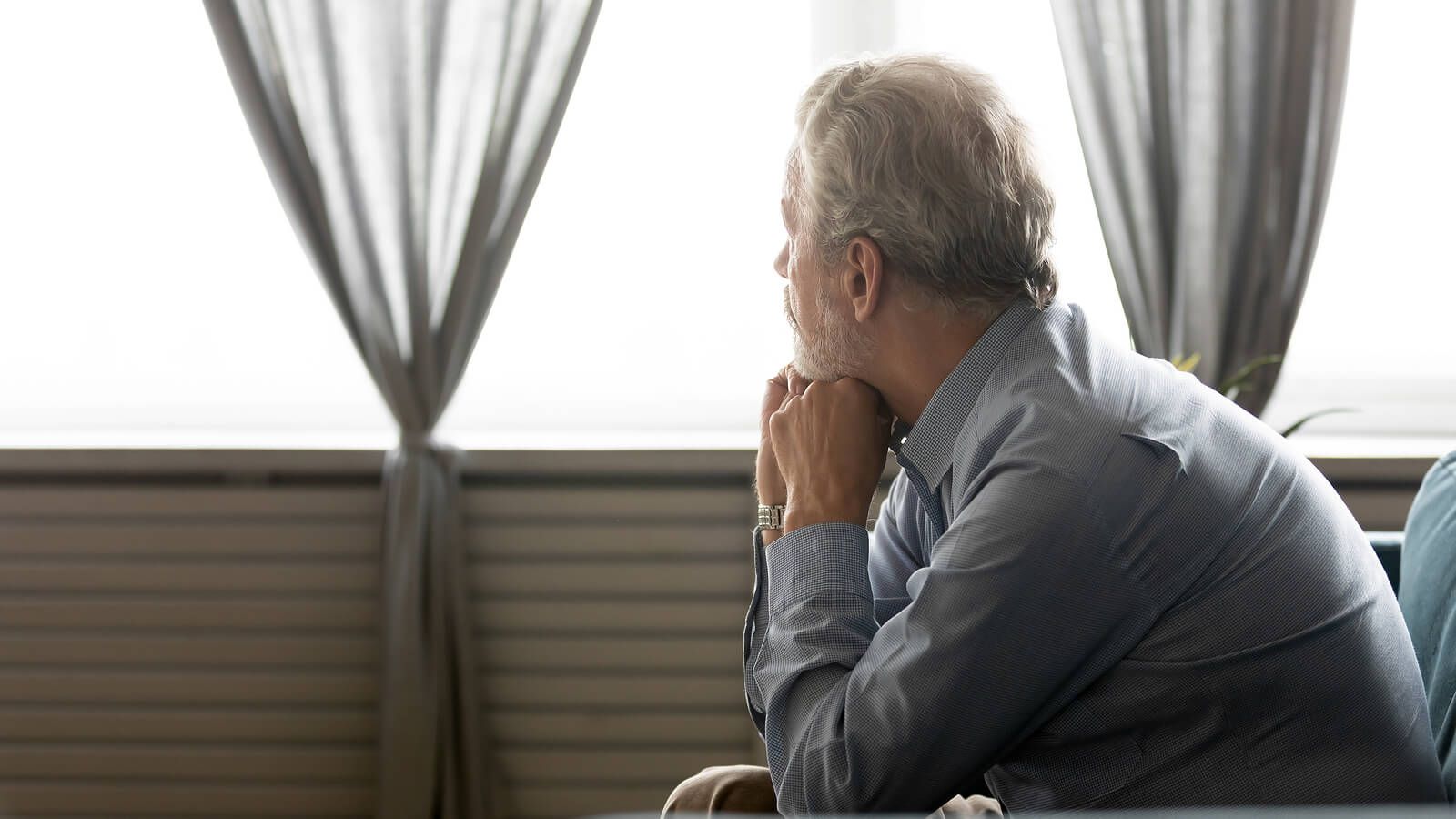 An elderly man sitting while looking out the window | grief therapist in san francisco, ca | grief therapy in san francisco, ca | grief counseling san francisco, ca | 94110 | 94112 | 94116