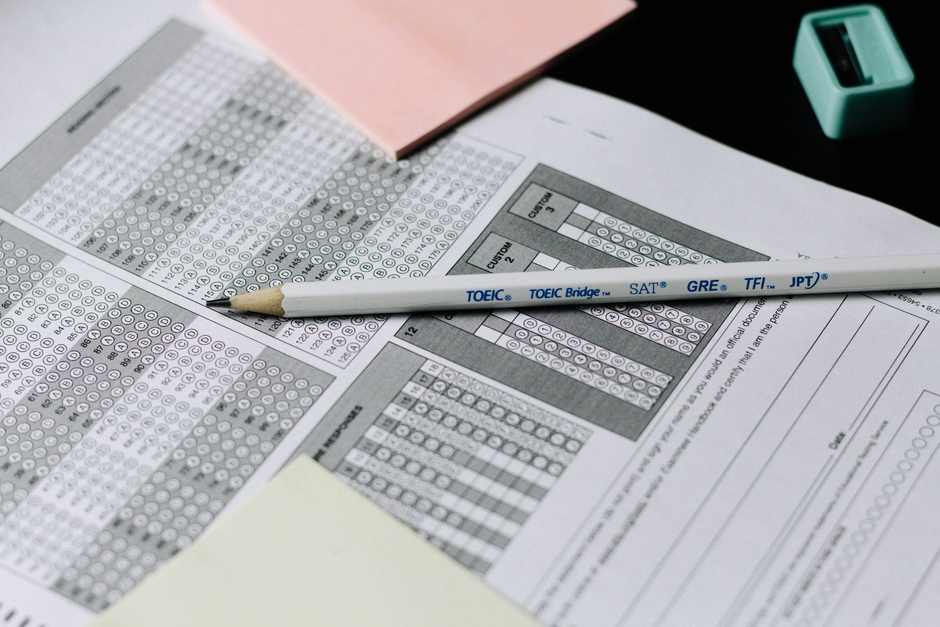 a scantron score card with a sharpened pencil laying on top