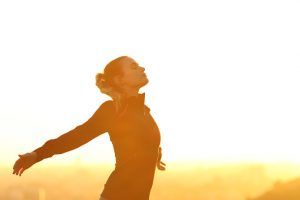 A woman standing in the sun reflecting on her day. Represents the need for self-awareness counseling in Katy, TX 77494