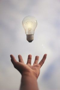 hand and a lightbulb, How to Counteract Negative Thinking Errors in Children blog, the counseling center at cinco ranch, katy texas 77494
