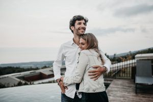 Man holding his wife and smiling after leaving marriage therapy in Katy, TX