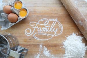 Af family baking together during the pandemic to relieve anxiety and they wrote family in flour on the table