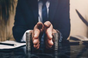 Businessman separates stack coins. Concept of saving and investing. Property division. Divorce and legal services. begin counseling today, counseling center at cinco ranch, katy texas 77474, overcoming gray divorce, late-life divorce blog