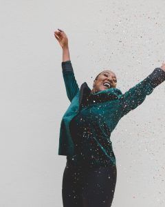 A woman celebrating after reaching the SMART goal she set for herself that she learned through therapy in Katy, TX 77494