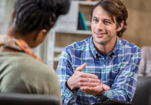 Two adult therapists discussing the benefits of talk therapy for individuals diagnosed with autism in Katy, TX 77494
