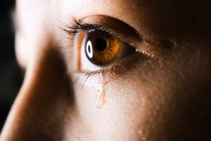 A young male teen with tears expressing signs of self harm and needing therapy to help him process his thoughts and behaviors