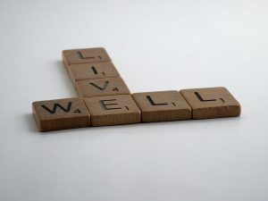Scrabble pieces that say "live well." Represent the need to learn about healthy boundaries in therapy in Katy, TX 77494