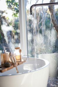 A bath being filled with water for a person wanting to explore self-care. Represents the need for self-care check and counseling in Katy, TX 77494