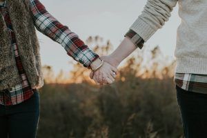 A man and woman holding hands to strengthen their relationship and connection