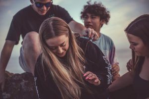 Teens enjoying time together after learning appropriate coping skills to manage self-harming behaviors in therapy in Katy, TX 77494