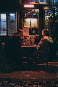 A couple sitting at a table not communicating and taking a break from one another. Represents the need for conflict resolution counseling in Katy, TX 77494