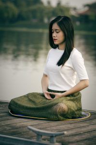 a woman practicing self-care by meditating after her counseling session in Katy, TX