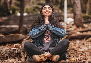 girl sitting in the woods or the forest looks happy and mindful after conquering anxiety, Acceptance and Commitment Therapy (ACT) for Anxiety blog, counseling center at cinco ranch, katy texas, fulshear texas, 77494, 77441