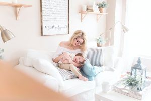 Mother and son sitting on the couch laughing. Represents the need for divorce counseling in Katy, TX 77494