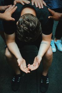 A man using a grounding technique he learned during his therapy session for PTSD