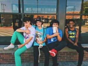 Four teen boys hanging out by a store. Represents the need for teen therapy in Katy, TX 77494. Represents the need for parenting teens and family therapy in Katy, TX 77494