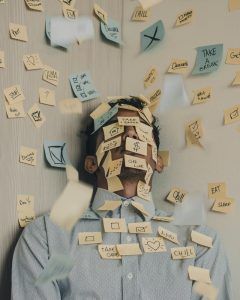 A young man with sticky notes all over his body that represent stress in his life. Represents the need for counseling for perfectionism in Katy, TX