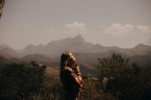 Woman regulating her emotions, standing by a mountain, How to Regulate Your Emotions blog, begin counseling today in katy texas at the counseling center at cinco ranch