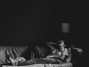 Person laying in bed, looking sad or depressed, black and white, Positive and Negative Self-Talk blog, counseling center at cinco ranch, katy texas 77494