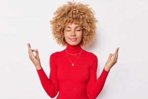 A woman with a red shirt on, being calm, collective, and zen, Spring Cleaning with Meaning blog, begin counseling today, katy texas 77494
